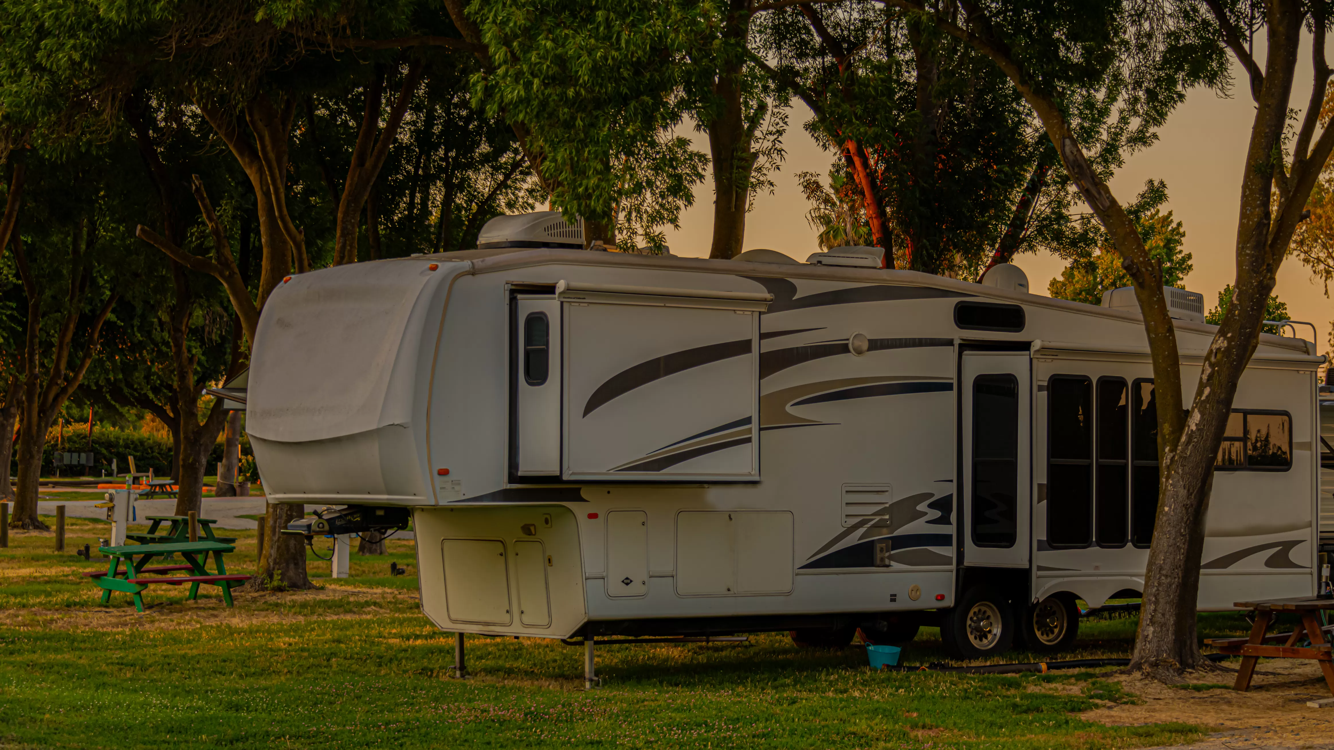 A recreational vehicle parked at a sunny Florida campsite